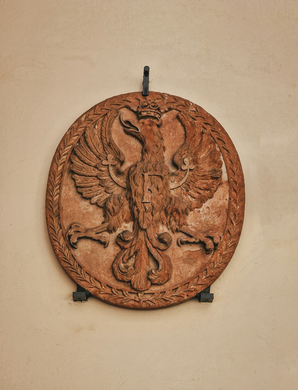 a wooden plaque with a bird on it