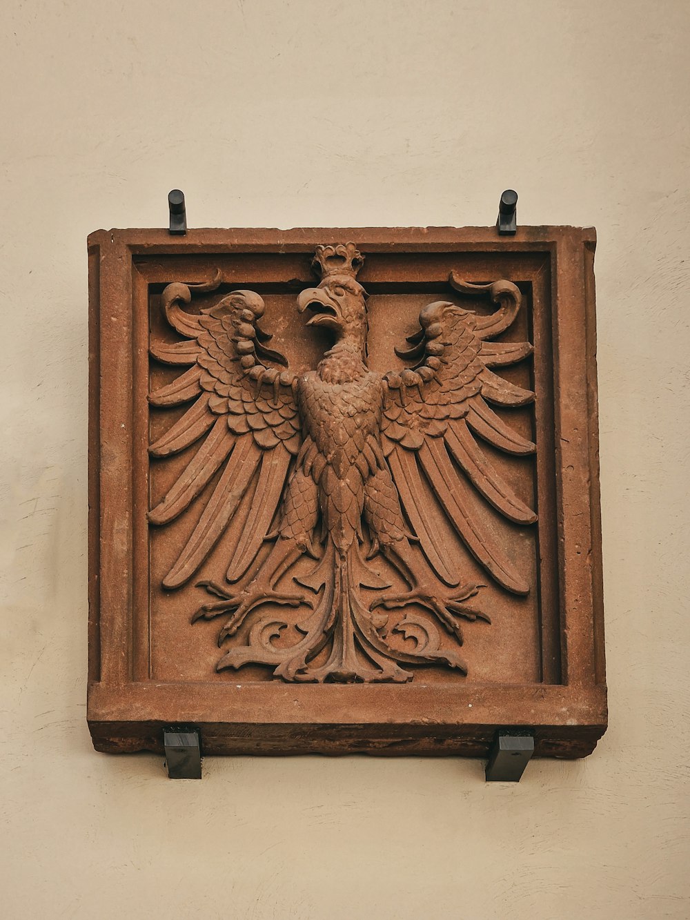 a decorative bird on the wall of a building