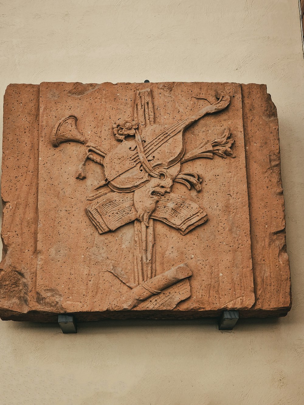 a stone carving of a cross on a wall