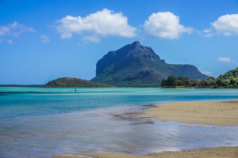 a beach with a mountain in the background