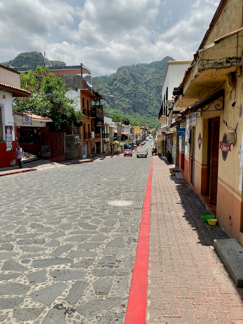 a street lined with buildings and a red curb