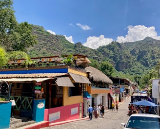 A vibrant photo of Kingstown’s main street bustling with residents during a sunny afternoon.