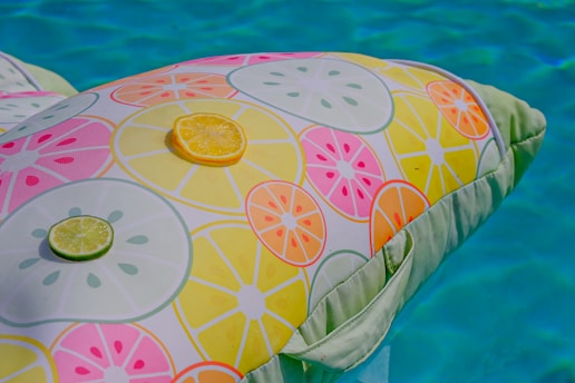 Colorful pool floats and water games in a sunny pool.