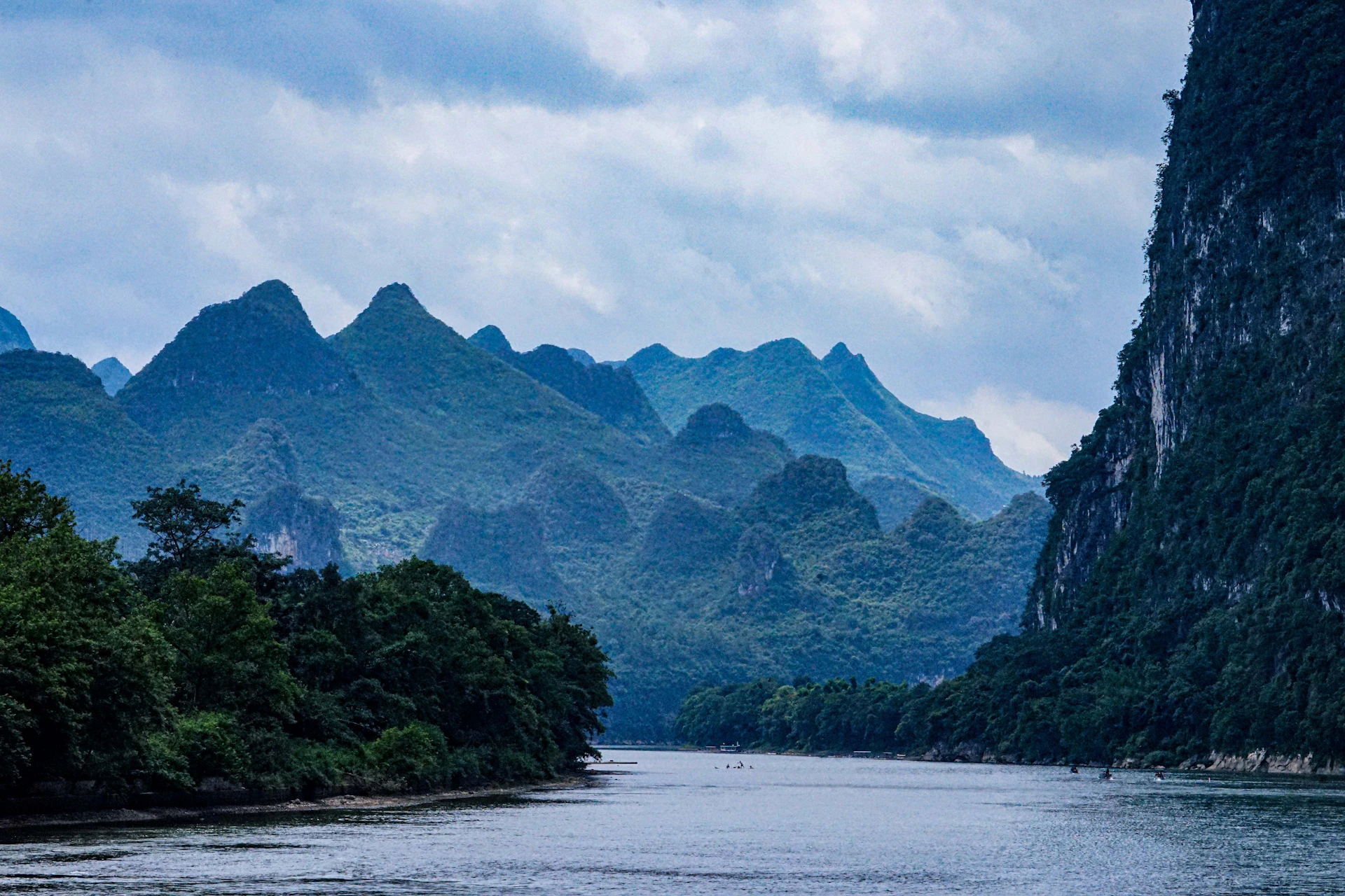 a body of water surrounded by mountains and trees
