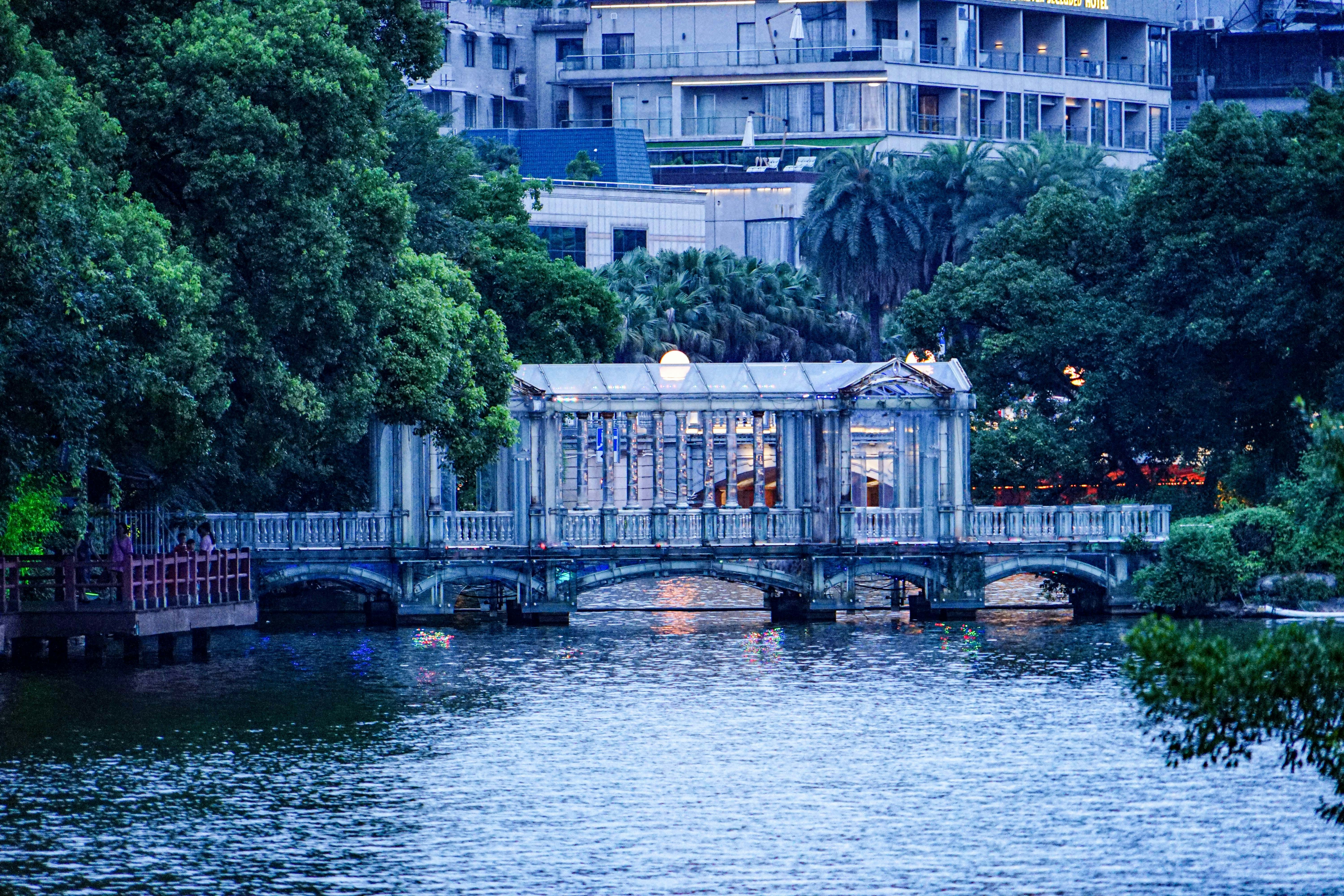 a bridge over a body of water with a building in the background