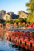 a large body of water filled with lots of red umbrellas