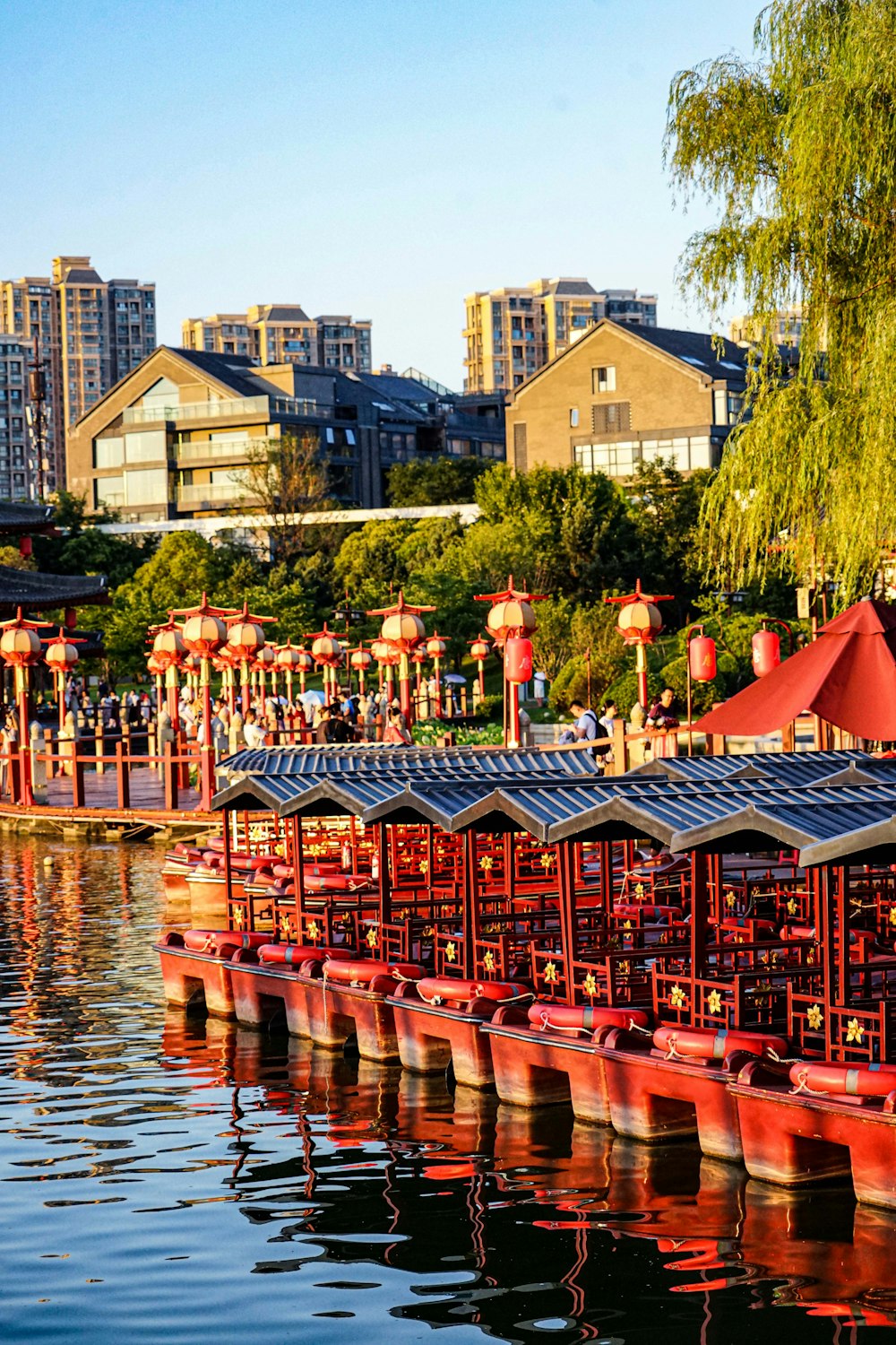 a large body of water filled with lots of red umbrellas