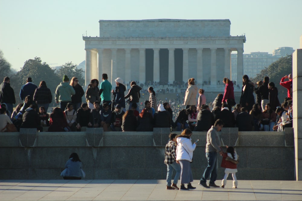 a large group of people standing around in front of a building