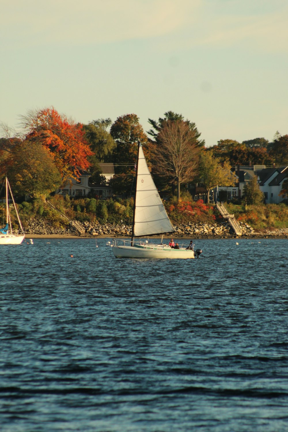 a couple of boats floating on top of a lake