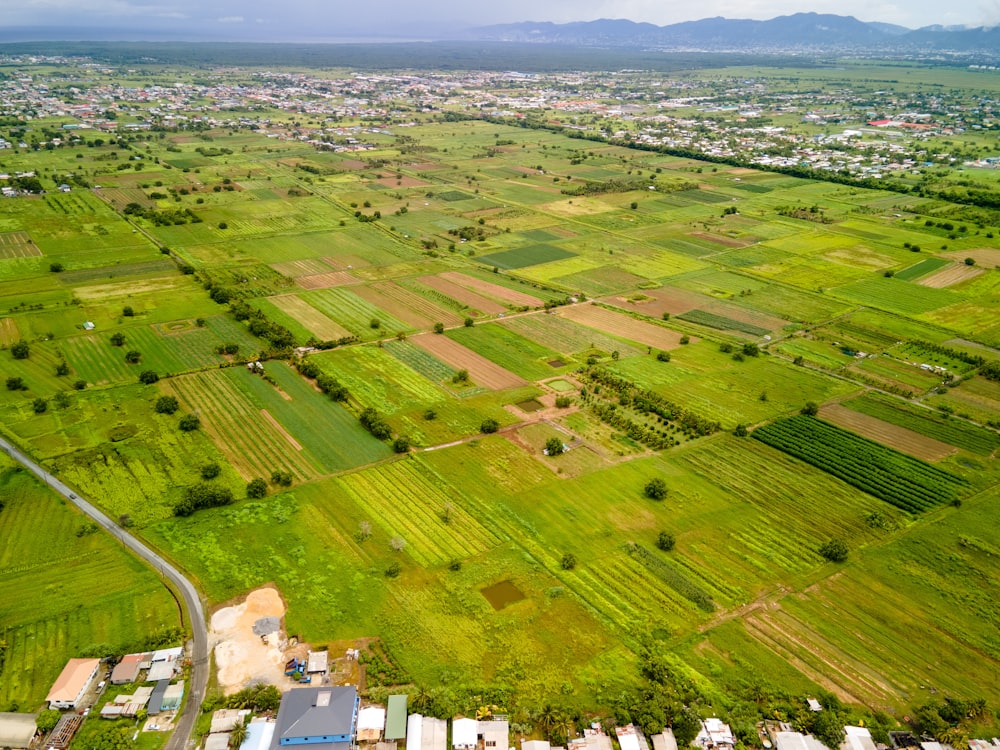 an aerial view of a large green field