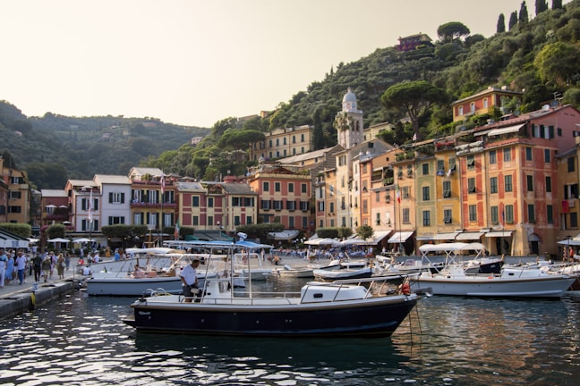 A scenic view of Sainte-Maxime harbor with a concierge walking along the promenade.