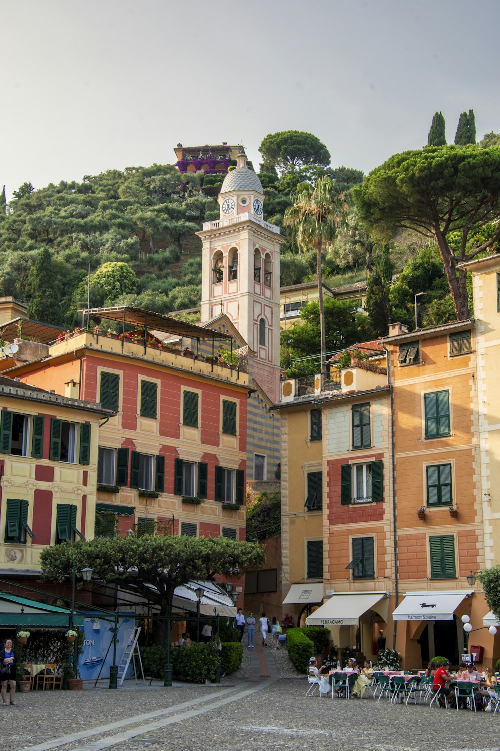 a group of buildings with a clock tower in the background