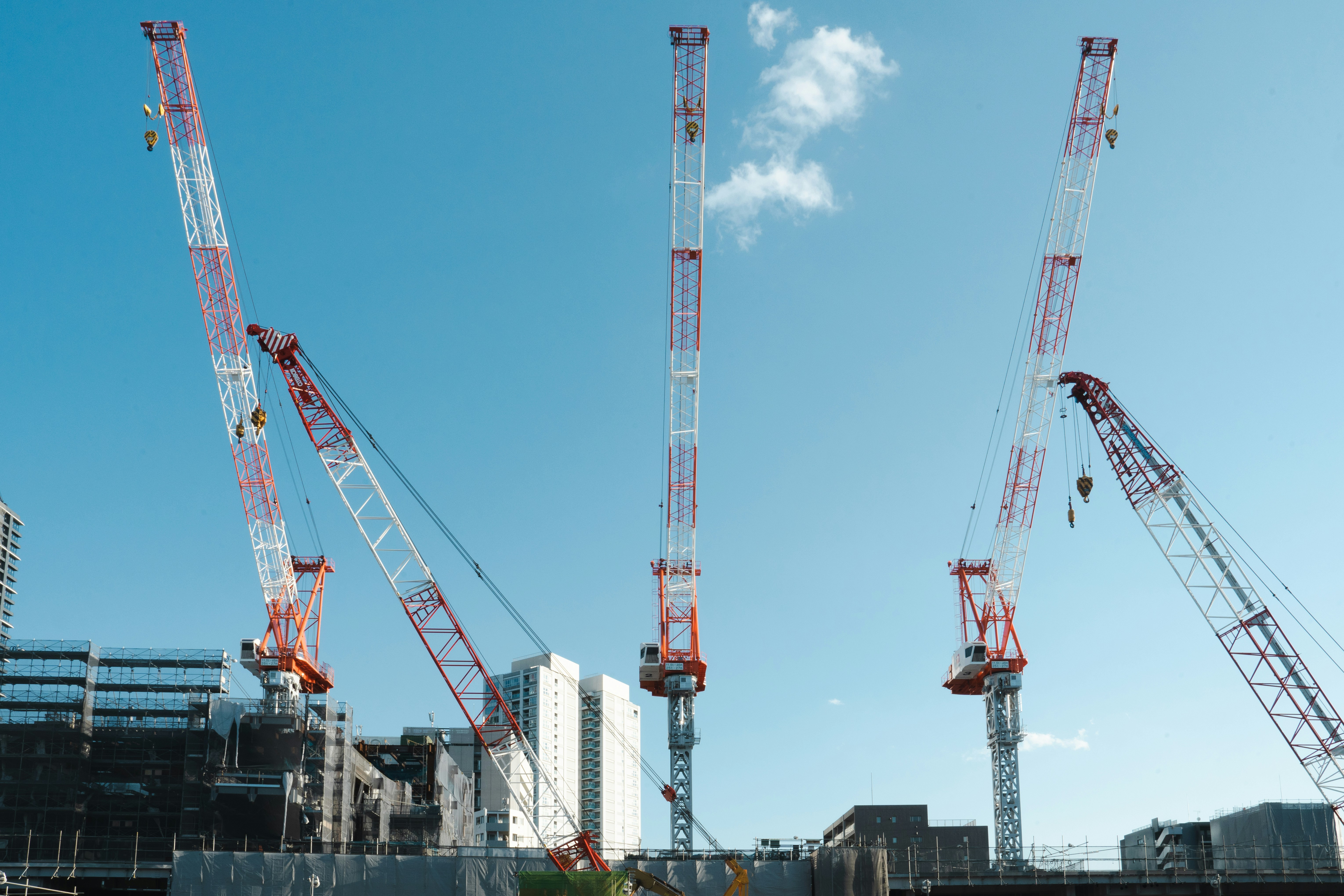 a group of cranes that are standing in the air