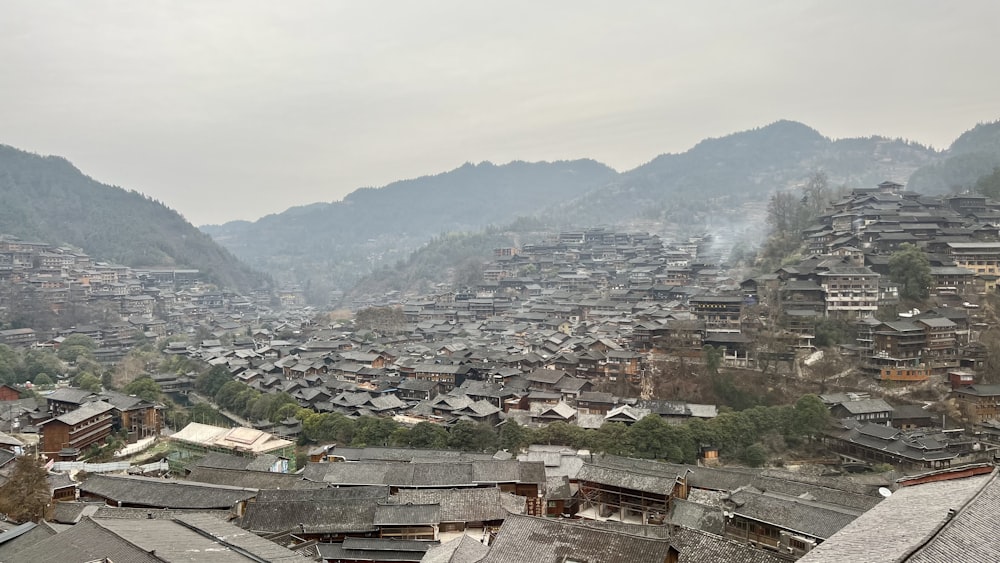 a view of a village with mountains in the background