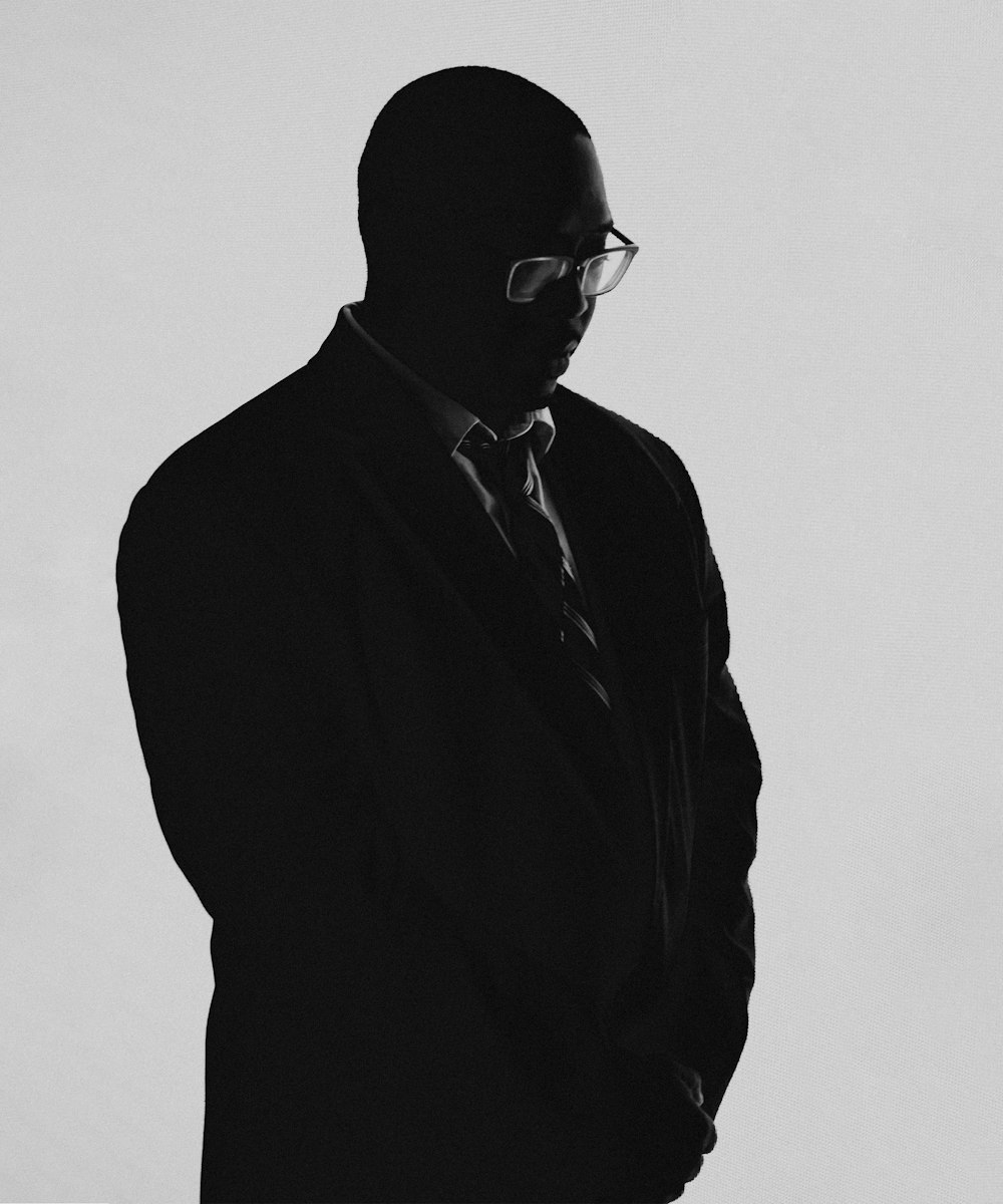 a black and white photo of a man in a suit