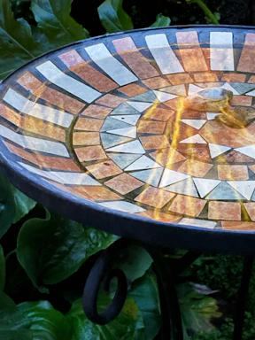 A close-up of a bright blue and green table surface with intricate patterns, showcasing the vibrant colors.