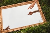 a person reaching out their hand to touch a mirror
