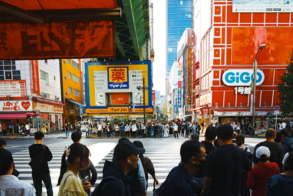 a crowd of people walking across a street