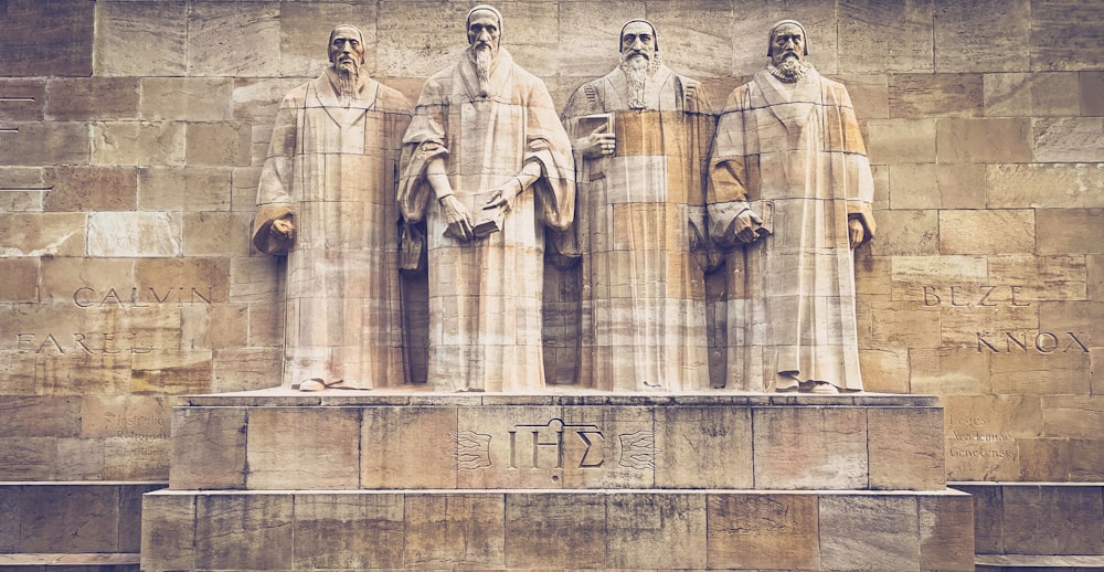 a group of statues of men standing next to each other