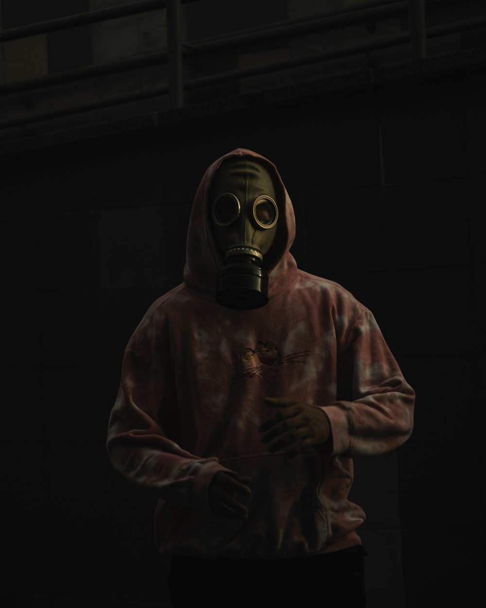 a man in a gas mask holding a cigarette