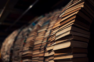 Panoramic view of a tunnel made of stacked books with a warm dark overlay