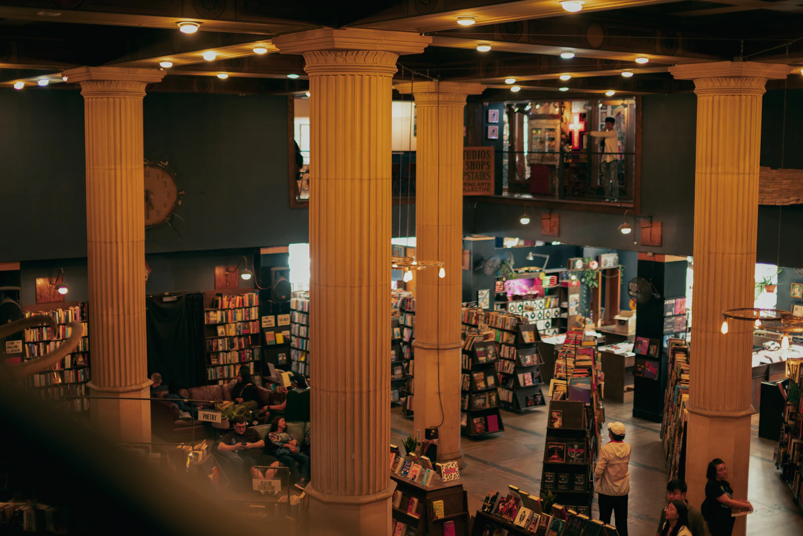 A library filled with lots of books and people