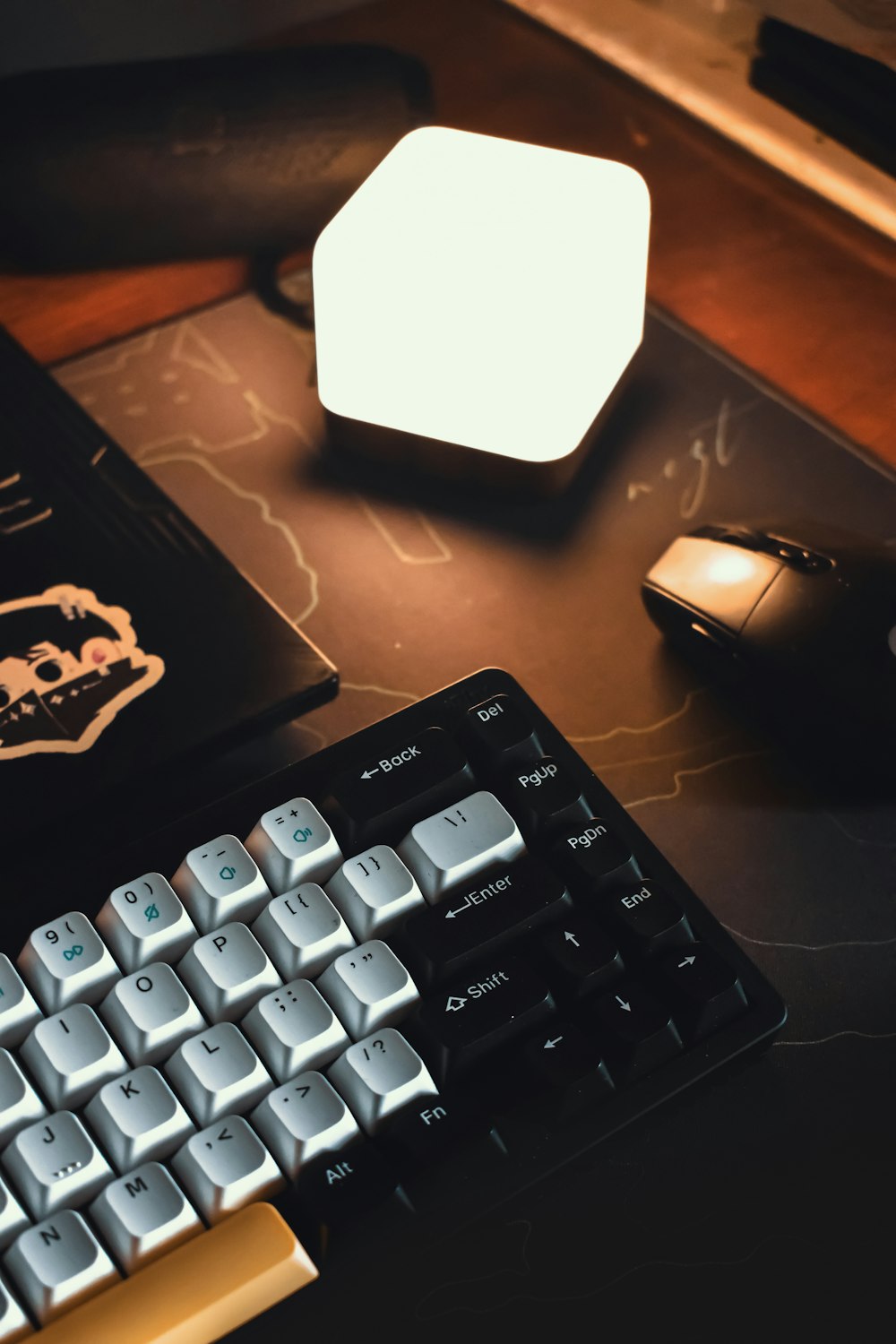 a computer keyboard and mouse on a desk