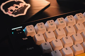 Close-up of a person typing on a keyboard with AI-themed stickers around.