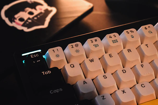 Close-up of a person typing on a keyboard with AI-themed stickers around.