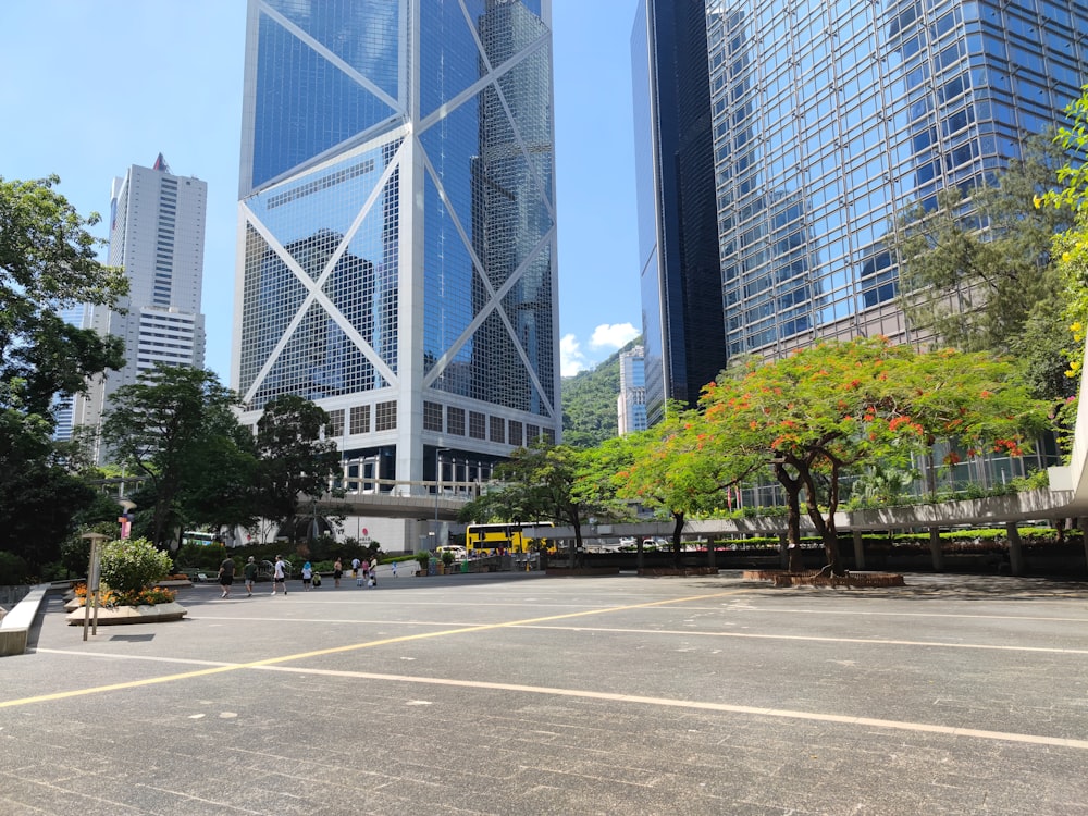 an empty parking lot in a city with tall buildings in the background
