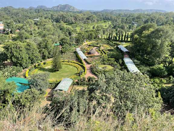 An aerial shot showing multiple land plots with winding paths and vibrant vegetation.