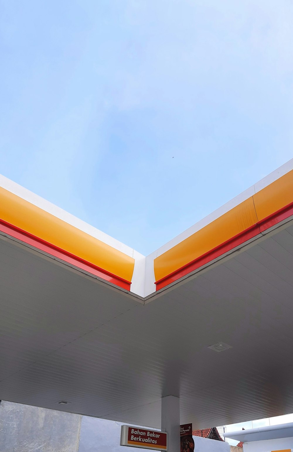 a gas station with a blue sky in the background