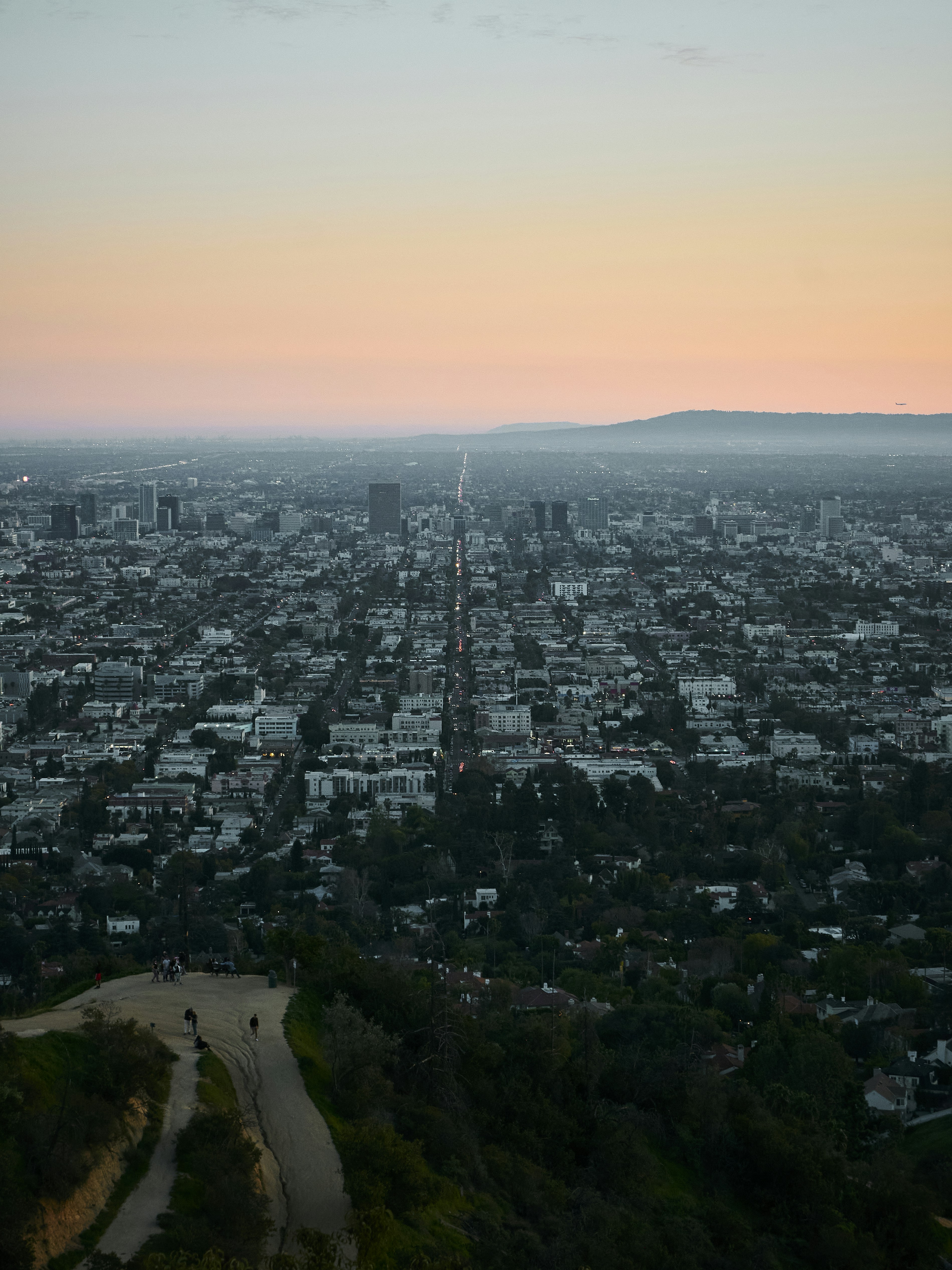 an aerial view of a city at sunset