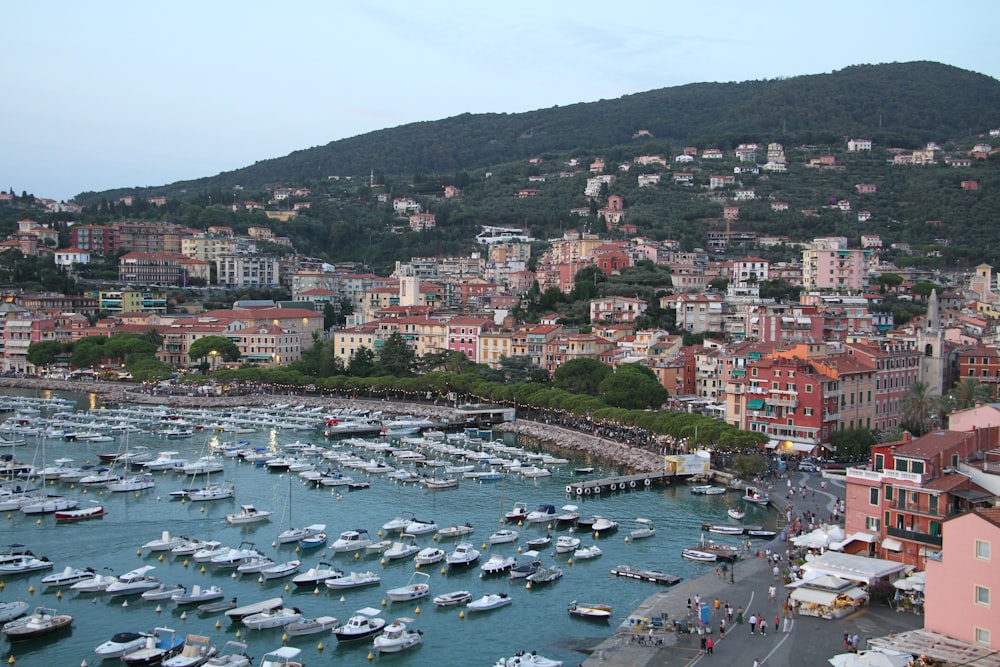 a harbor filled with lots of boats next to a city