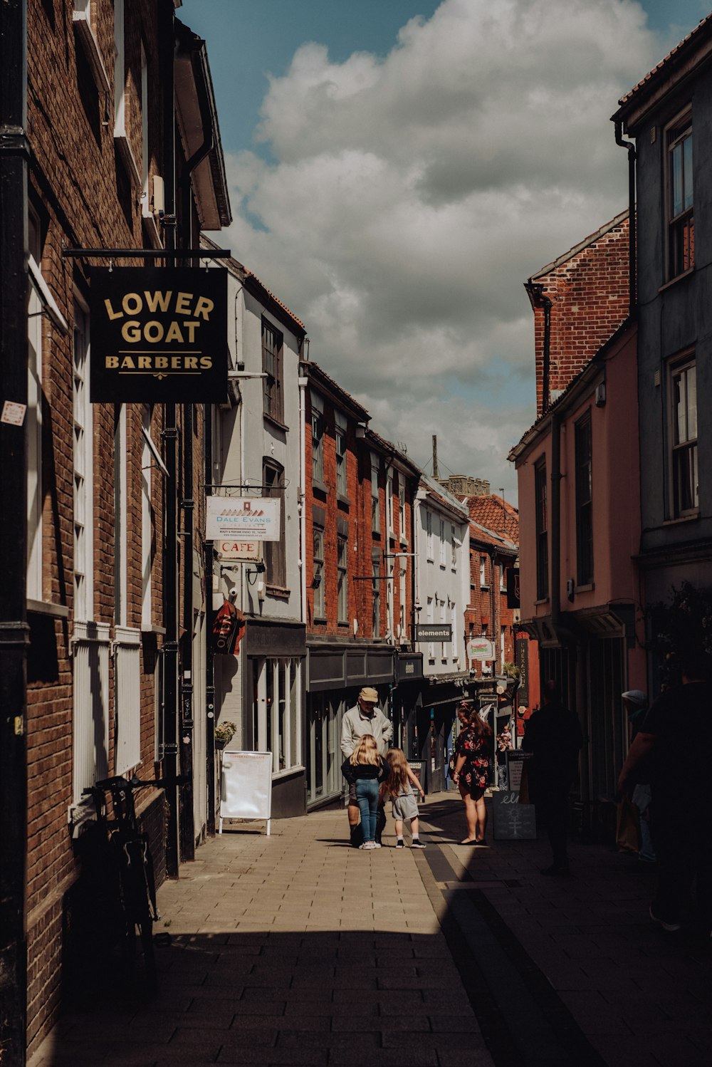 a couple of people that are walking down a street