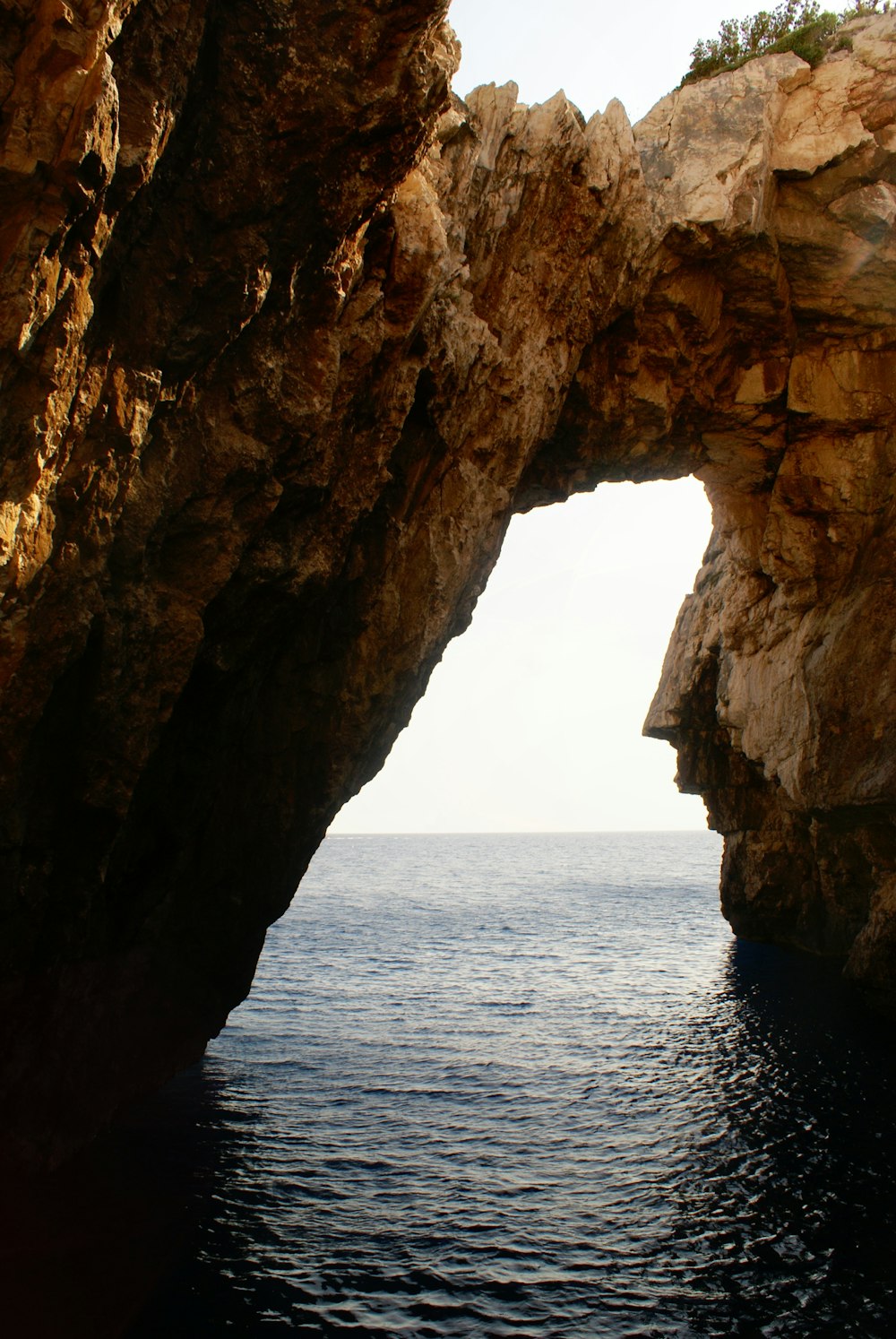 a large rock formation over a body of water