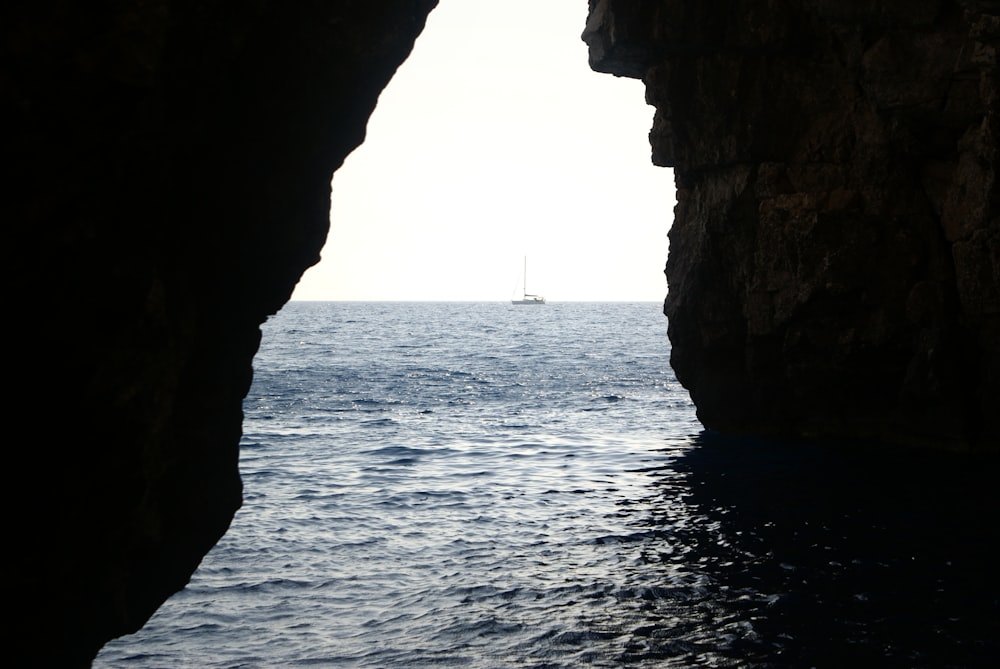 a boat is sailing in the ocean through a cave