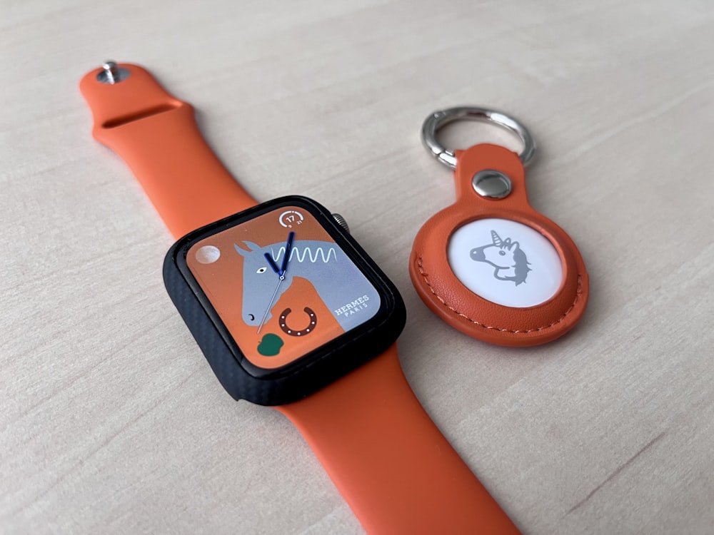 an orange apple watch with an orange strap