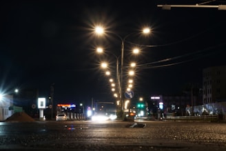 Bright solar street lights illuminating a quiet evening street.
