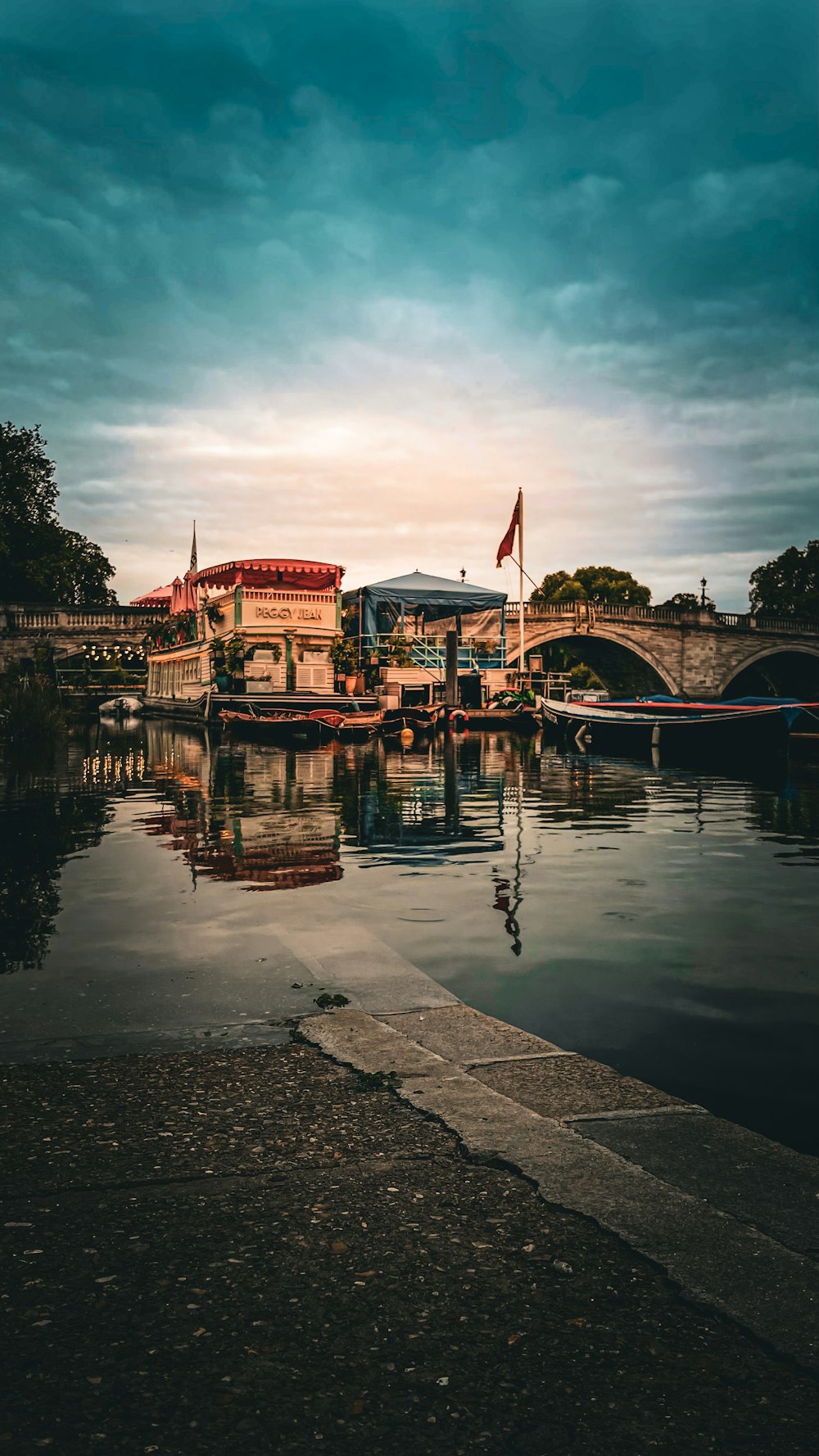 a body of water with a bridge in the background