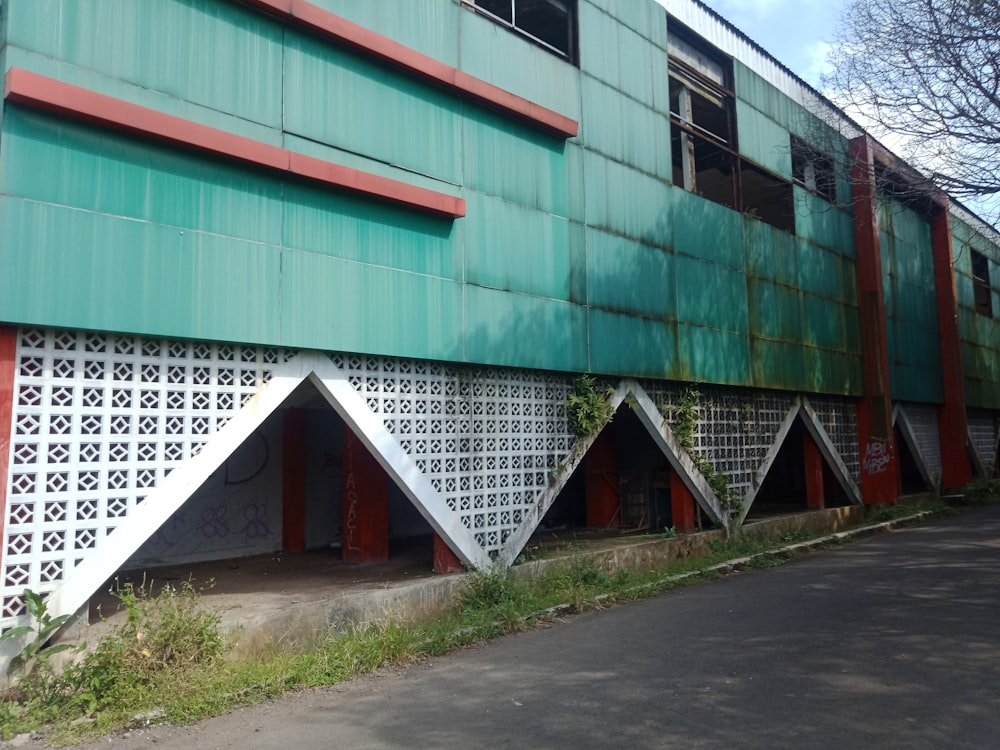 a green building with red and white designs on it