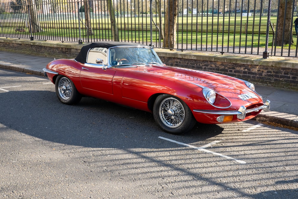 a red sports car parked in a parking lot