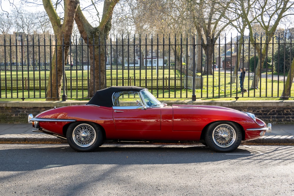 a red sports car parked on the side of the road