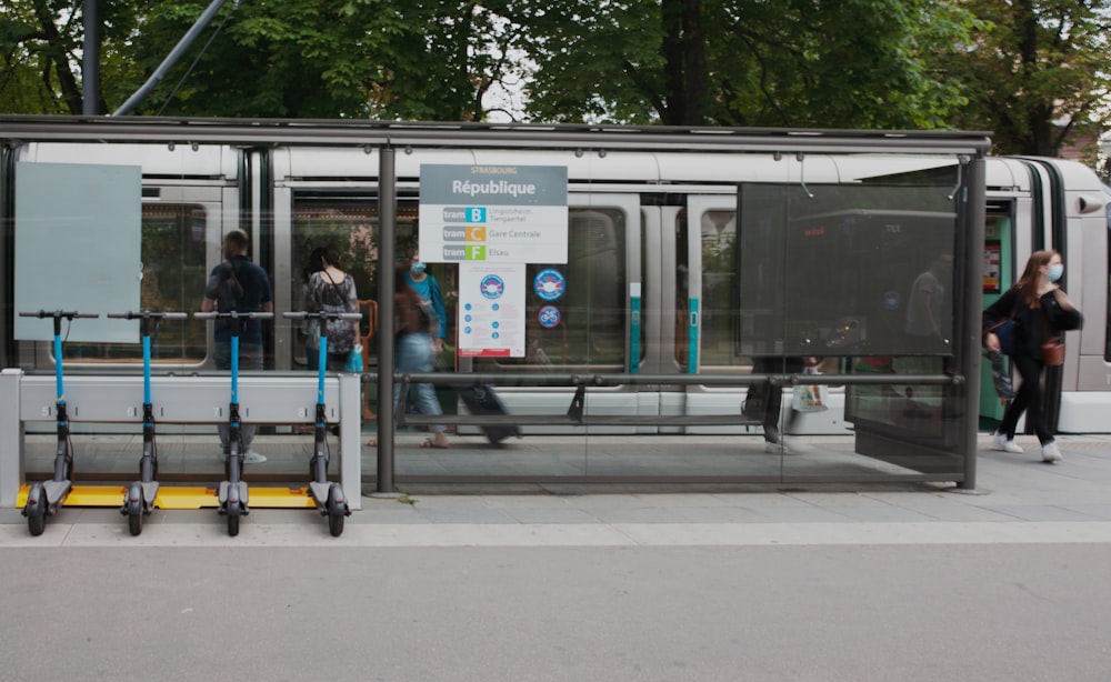 a bus stop with people waiting for the bus