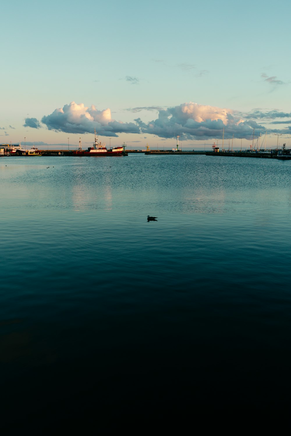 a large body of water with a boat in the distance