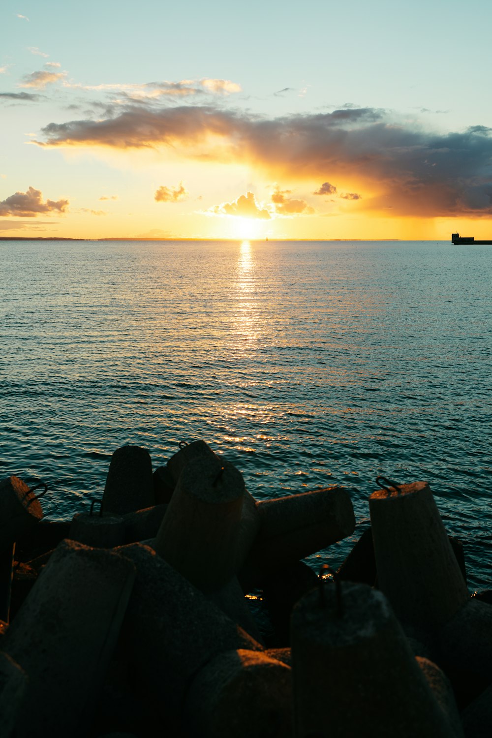 a large body of water with a boat in the distance