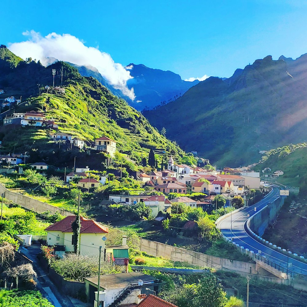 a scenic view of a small town in the mountains