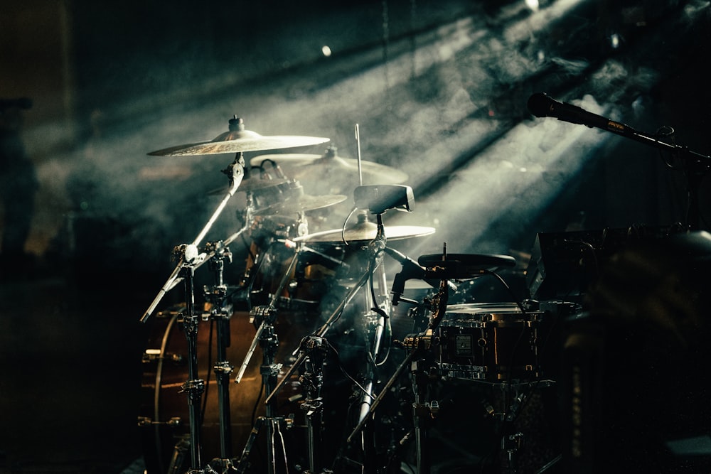 a drum set up in front of a stage light