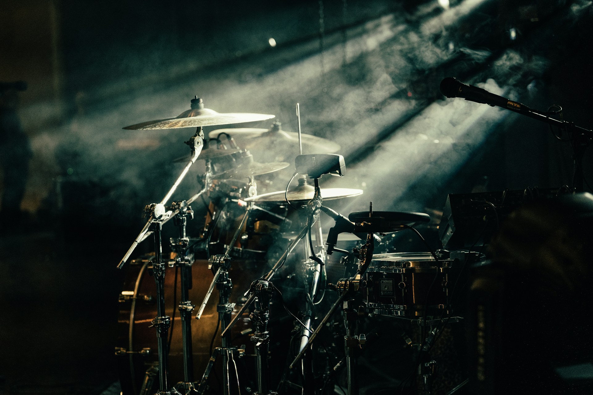 a drum set up in front of a stage light