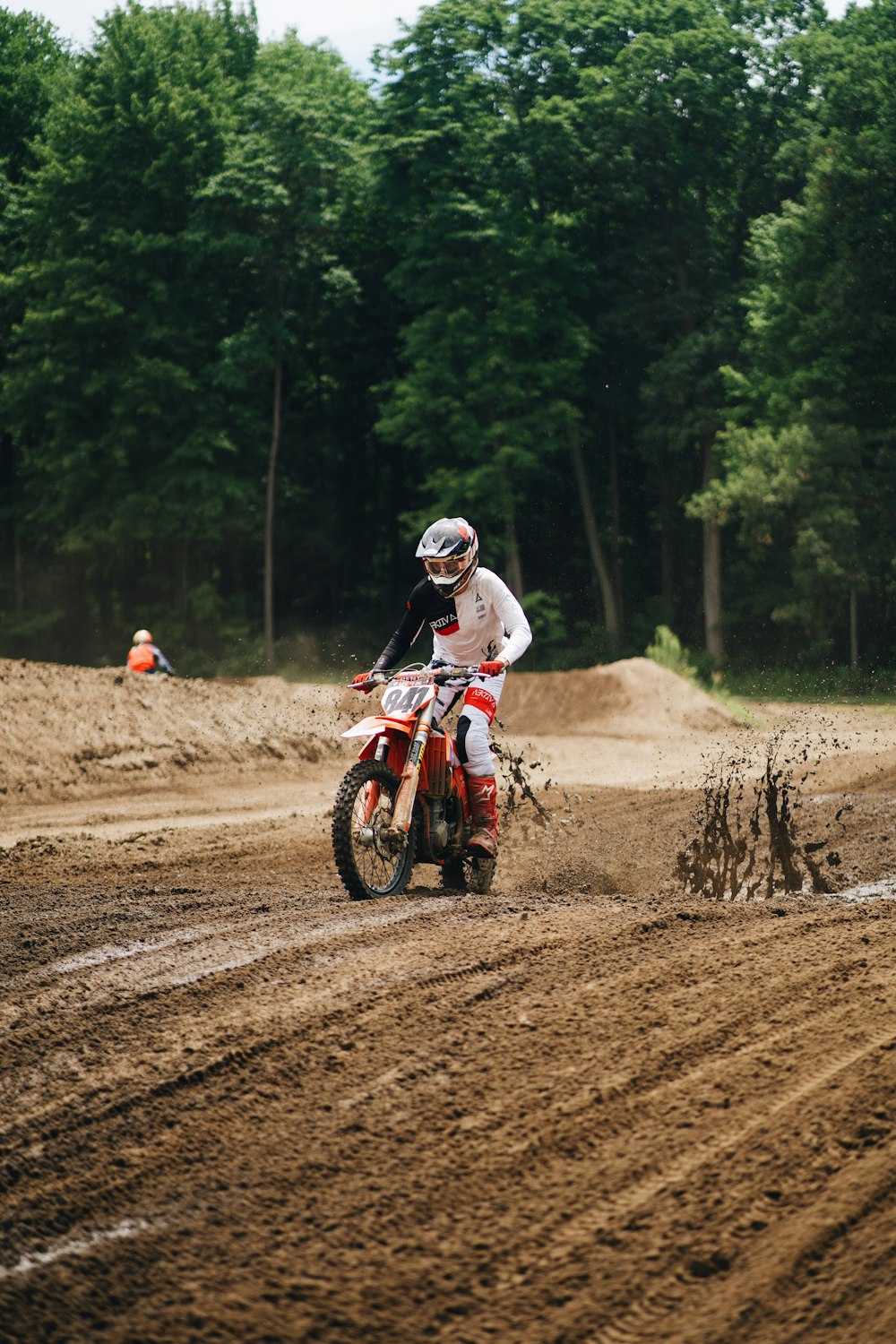 a man riding a dirt bike on top of a dirt field